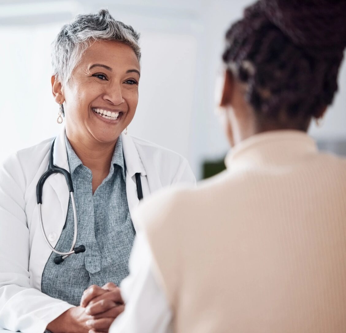Two physicians in a warm, conversational consultation